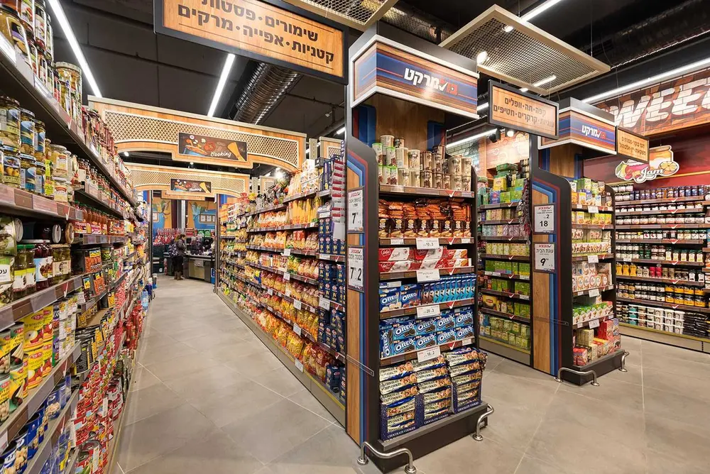 Bol Market minimarket interior with branded retail aisles, custom shelving, overhead signage, and integrated lighting.