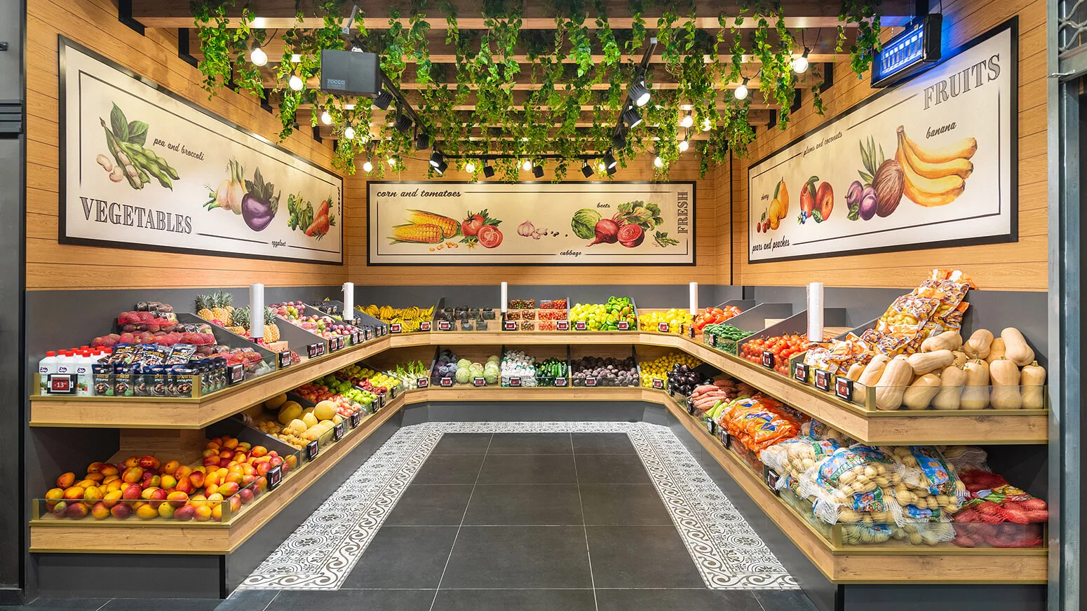 Shefa Market supermarket produce section with wooden displays, fresh fruits and vegetables, and decorative greenery.